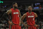 CHICAGO, IL - APRIL 12:  Dwyane Wade #3 and LeBron James #6 of the Miami Heat wait as a member of the Chicago Bulls shoots a free-throw at the United Center on April 12, 2012 in Chicago, Illinois. The Bulls defeated the Heat 96-86 in overtime. NOTE TO USER: User expressly acknowledges and agrees that, by downloading and or using this photograph, User is consenting to the terms and conditions of the Getty Images License Agreement.  (Photo by Jonathan Daniel/Getty Images)