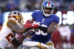 EAST RUTHERFORD, NJ - DECEMBER 18:  Hakeem Nicks #88 of the New York Giants holds onto the ball with coverage by DeAngelo Hall #23 and Oshiomogho Atogwe #20 of the Washington Redskins during their game at MetLife Stadium on December 18, 2011 in East Rutherford, New Jersey.  (Photo by Jeff Zelevansky/Getty Images)