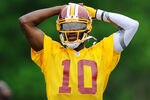 ASHBURN, VA - MAY 06:  Robert Griffin III #10 of the Washington Redskins practices during the Washington Redskins rookie minicamp on May 6, 2012 in Ashburn, Virginia.  (Photo by Patrick McDermott/Getty Images)