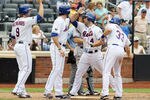 NEW YORK, NY - MAY 26:  Mike Nickeas #4 of the New York Mets celebrates his eighth inning grand slam against the San Diego Padres with teammates Kirk Nieuwenhuis #9, Ike Davis #29 and  Vinny Rottino #33 at Citi Field on May 26, 2012 in the Flushing neighborhood of the Queens borough of New York City.  (Photo by Jim McIsaac/Getty Images)