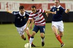 JACKSONVILLE, FL - MAY 26:  Landon Donovan #10 of Team USA , is defended by Charlie Mulgrew #3 and Scott Brown #8 of Team Scotland on May 26, 2012 at EverBank Field in Jacksonville, Florida. (Photo by Gary Bogdon/Getty Images)