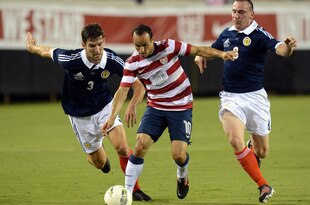 JACKSONVILLE, FL - MAY 26:  Landon Donovan #10 of Team USA , is defended by Charlie Mulgrew #3 and Scott Brown #8 of Team Scotland on May 26, 2012 at EverBank Field in Jacksonville, Florida. (Photo by Gary Bogdon/Getty Images)
