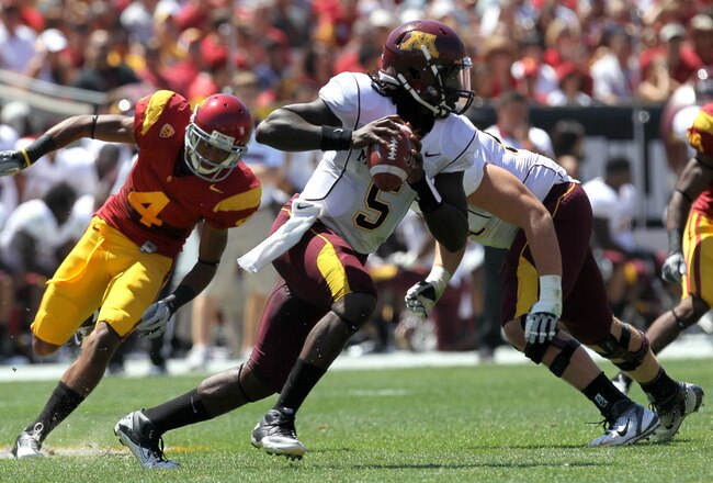 LOS ANGELES, CA - SEPTEMBER 03:  Quarterback MarQueis Gray #5 of the Minnesota Golden Gophers rolls out with the ball against the USC Trojans at the Los Angeles Memorial Coliseum on September 3, 2011 in Los Angeles, California. USC won 19-17.  (Photo by Stephen Dunn/Getty Images)