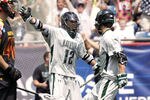 FOXBORO, MA - MAY 28:  Eric Lusby #12 of the Loyola Greyhounds celebrates goal with teammate Phil Dobson #22 as Brian Cooper #40 of the Maryland Terripans looks on during the first half of the 2012 NCAA Division I Men's Lacrosse Championship game at Gillette Stadium on May 28, 2012 in Foxboro, Massachusetts.  (Photo by Winslow Townson/Getty Images)