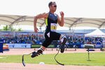 MANCHESTER, ENGLAND - MAY 22:  Oscar Pistorius of South Africa on his way to victory in the men's T42/43/44 200m during day one of the BT Paralympic World Cup at Sportcity on May 22, 2012 in Manchester, England.  (Photo by Michael Steele/Getty Images)