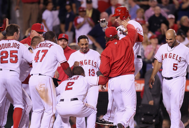 ANAHEIM, CA - MAY 28:  Mark Trumbo (2nd from right) #44 of the Los Angeles Angels of Anaheim is congratulated by his teammates after hitting a walk off home run in the ninth inning against the New York Yankees at Angel Stadium of Anaheim on May 28, 2012 in Anaheim, California. The Angels defeated the Yankees 9-8.  (Photo by Jeff Gross/Getty Images)