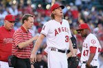 ANAHEIM, CA - MAY 28:  Starting pitcher Jered Weaver #36 of the Los Angeles Angels of Anaheim is attended to after injuring himself, as manager Mike Scioscia (L) and Howard Kendrick (R) #47 look on in the first inning against the New York Yankees at Angel Stadium of Anaheim on May 28, 2012 in Anaheim, California.  (Photo by Jeff Gross/Getty Images)