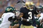 SOUTH BEND, IN - SEPTEMBER 03:  Michael Floyd #3 of the Notre Dame Fighting Irish is hit by Jon Lejiste #8 of the University of South Florida Bulls at Notre Dame Stadium on September 3, 2011 in South Bend, Indiana. South Florida defeated Notre Dame 23-20.  (Photo by Jonathan Daniel/Getty Images)