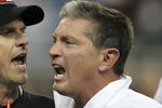 DETROIT - OCTOBER 16:  Jim Harbaugh head coach of the San Francisco 49ers argues with Jim Schwartz of the Detroit Lions during the NFL game at Ford Field on October 16, 2011 in Detroit, Michigan. The 49ers defeated the Lions 25-19.  (Photo by Leon Halip/Getty Images)