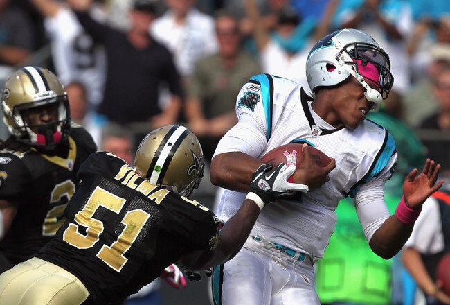 CHARLOTTE, NC - OCTOBER 09:   Jonathan Vilma #51 of the New Orleans Saints tackles Cam Newton #1 of the Carolina Panthers during their game at Bank of America Stadium on October 9, 2011 in Charlotte, North Carolina.  (Photo by Streeter Lecka/Getty Images)