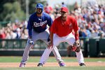 TEMPE, AZ - MARCH 12:  Matt Kemp #27 of the Los Angeles Dodgers leads off first base behind Albert Pujols #5 of the Los Angeles Angels of Anaheim in the second inning of a spring training baseball game at Tempe Diablo Stadium on March 12, 2012 in Tempe, Arizona.  (Photo by Kevork Djansezian/Getty Images)