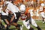 AUSTIN, TX - OCTOBER 15:  Defensive end Alex Okafor #80 of the Texas Longhorns tackles running back Joseph Randle #1 of the Oklahoma State Cowboys in the fourth quarter on October 15, 2011 at Darrell K. Royal-Texas Memorial Stadium in Austin, Texas.  Oklahoma State beat Texas 38-26.  (Photo by Erich Schlegel/Getty Images)