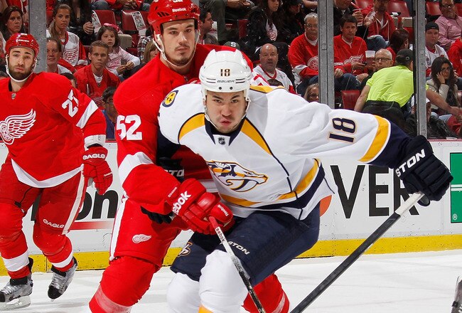 DETROIT, MI - APRIL 17: Brandon Yip #18 of the Nashville Predators battles for the puck with Jonathan Ericsson #52 of the Detroit Red Wings during the first period in Game Four of the Western Conference Quarterfinals during the 2012 NHL Stanley Cup Playoffs at Joe Louis Arena on April 17, 2012 in Detroit, Michigan. (Photo by Gregory Shamus/Getty Images)