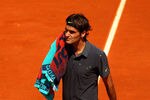 PARIS, FRANCE - MAY 28:  Roger Federer of Switzerland wipes his face with a towel during a break in the men's singles first round match between Roger Federer of Switzerland and Tobias Kamke of Germany during day two of the French Open at Roland Garros on May 28, 2012 in Paris, France.  (Photo by Clive Brunskill/Getty Images)