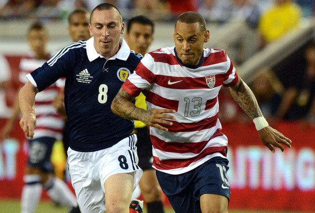 JACKSONVILLE, FL - MAY 26:  Jermaine Jones #13 of team USA beats Scott Brown #8 of Team Scotland to the ball on May 26, 2012 at EverBank Field in Jacksonville, Florida. (Photo by Gary Bogdon/Getty Images)
