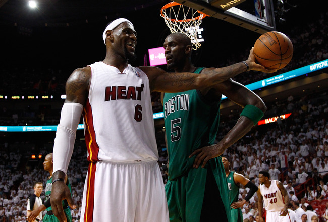 MIAMI, FL - MAY 28:  LeBron James #6 of the Miami Heat smiles as he holds out the ball in the second half against Kevin Garnett #5 of the Boston Celtics in Game One of the Eastern Conference Finals in the 2012 NBA Playoffs on May 28, 2012 at American Airlines Arena in Miami, Florida.  NOTE TO USER: User expressly acknowledges and agrees that, by downloading and or using this photograph, User is consenting to the terms and conditions of the Getty Images License Agreement.  (Photo by Mike Ehrmann/Getty Images)