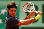 PARIS, FRANCE - MAY 30:  Roger Federer of Switzerland plays a backhand during his men's singles second round match against Adrian Ungur of Romania during day four of the French Open at Roland Garros on May 30, 2012 in Paris, France.  (Photo by Clive Brunskill/Getty Images)