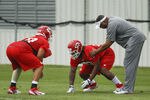 KANSAS CITY, MO - MAY 13:  Ethan Johnson #70 and Dontari Poe #92 of the Kansas City Chiefs work with defensive coach Anthony Pleasant during the Kansas City Chiefs minicamp on May 13, 2012 at the Chiefs Training Facility in Kansas City, Missouri. (Photo by Kyle Rivas/Getty Images)