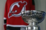 NEWARK, NJ - MAY 29:  The Stanley Cup is displayed next to a New Jersey Devils' Jersey during Media Day for the 2012 Stanley Cup Final at Prudential Center on May 29, 2012 in Newark, New Jersey.  (Photo by Bruce Bennett/Getty Images)