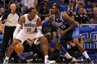 ORLANDO, FL - MARCH 30:  Dwight Howard #12 of the Orlando Magic drives aganst Ian Mahinmi #28 of the Dallas Mavericks during the game at Amway Center on March 30, 2012 in Orlando, Florida.  NOTE TO USER: User expressly acknowledges and agrees that, by downloading and or using this photograph, User is consenting to the terms and conditions of the Getty Images License Agreement.  (Photo by Sam Greenwood/Getty Images)