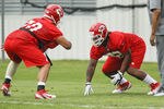 KANSAS CITY, MO - May 13:  Ethan Johnson #70 and Dontari Poe #92 of the Kansas City Chiefs work with defensive coach Anthony Pleasant during the Kansas City Chiefs Minicamp on May 13, 2012 at the Chiefs Training Facility in Kansas City, Missouri. (Photo by Kyle Rivas/Getty Images)