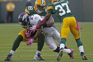GREEN BAY, WI - OCTOBER 2: Knowshon Moreno #27 of the Denver Broncos gets hit by C.J. Wilson #98 and Sam Shields #37 of the Green Bay Packers at Lambeau Field on October 2, 2011 in Green Bay, Wisconsin.  (Photo by Matt Ludtke /Getty Images)