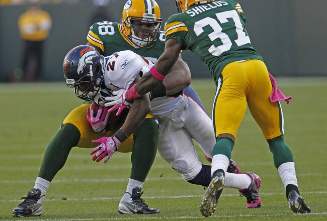 GREEN BAY, WI - OCTOBER 2: Knowshon Moreno #27 of the Denver Broncos gets hit by C.J. Wilson #98 and Sam Shields #37 of the Green Bay Packers at Lambeau Field on October 2, 2011 in Green Bay, Wisconsin.  (Photo by Matt Ludtke /Getty Images)