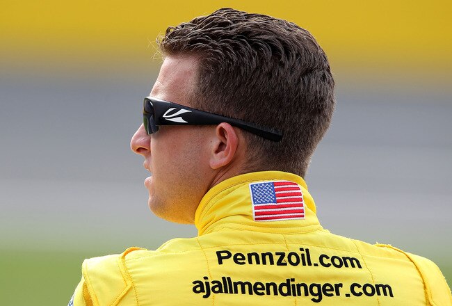 CHARLOTTE, NC - MAY 18:  AJ Allmendinger, driver of the #22 Pennzoil Dodge, stands on the grid during qualifying for the NASCAR Sprint Showdown at Charlotte Motor Speedway on May 18, 2012 in Charlotte, North Carolina.  (Photo by Scott Halleran/Getty Images for NASCAR)