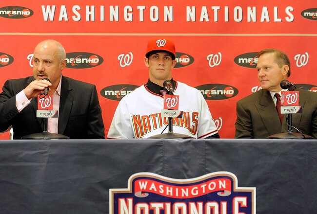 WASHINGTON - AUGUST 26:  General Manger Mike Rizzo, Bryce Harper #34 of the Washington Nationals and Scott Boras talk to the media during a press conference at Nationals Park on August 26, 2010 in Washington, DC.  (Photo by Greg Fiume/Getty Images)