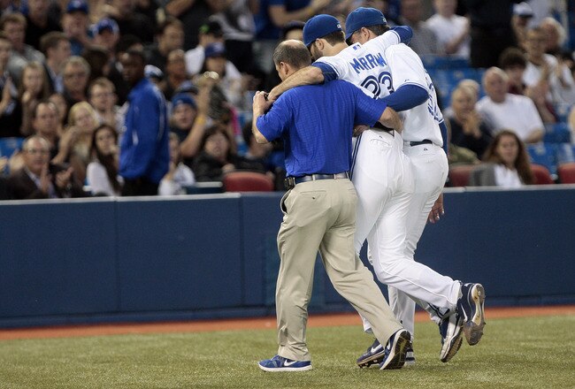 TORONTO, CANADA - MAY 30: Brandon Morrow #23 of the Toronto Blue Jays is helped off the field after being hit by a line drive against the Baltimore Orioles during MLB action at The Rogers Centre May 30, 2012 in Toronto, Ontario, Canada.  (Photo by Abelimages/Getty Images)