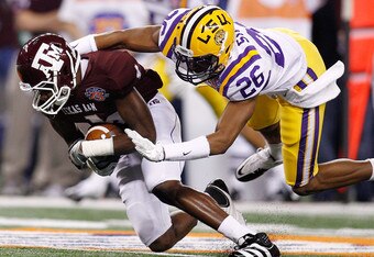 ARLINGTON, TX - JANUARY 07:  Brandal Jackson #4 of the Texas A&M Aggies is tackled by Tharold Simon #26 of the Louisiana State University Tigers during the AT&T Cotton Bowl at Cowboys Stadium on January 7, 2011 in Arlington, Texas.  (Photo by Chris Graythen/Getty Images)