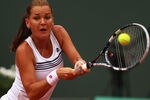 PARIS, FRANCE - MAY 30:  Agnieszka Radwanska of Poland plays a backhand during her women's singles second round match against Venus Williams of USA during day four of the French Open at Roland Garros on May 30, 2012 in Paris, France.  (Photo by Clive Brunskill/Getty Images)