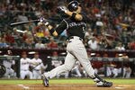 PHOENIX, AZ - AUGUST 29:  Carlos Gonzalez #5 of the Colorado Rockies bats against the Arizona Diamondbacks during the Major League Baseball game at Chase Field on August 29, 2011 in Phoenix, Arizona.  The Diamondbacks defeated the Rockies 5-1.  (Photo by Christian Petersen/Getty Images)