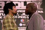 BEVERLY HILLS, CA - FEBRUARY 21:  Manny Pacquiao (L) and Timothy Bradley pose for photographers at a press conference announcing their upcoming World Boxing Organization welterweight championship fight at The Beverly Hills Hotel on February 21, 2012 in Beverly Hills, California.  (Photo by Stephen Dunn/Getty Images)