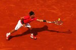 PARIS, FRANCE - MAY 31:  Rafael Nadal of Spain stretches for a backhand during his men's singles second round match against Denis Istomin of Uzbekistan during day five of the French Open at Roland Garros on May 31, 2012 in Paris, France.  (Photo by Clive Brunskill/Getty Images)