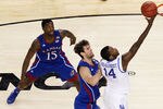 NEW ORLEANS, LA - APRIL 02:  Michael Kidd-Gilchrist #14 of the Kentucky Wildcats lays the ball up in front of Jeff Withey #5 of the Kansas Jayhawks in the first half in the National Championship Game of the 2012 NCAA Division I Men's Basketball Tournament at the Mercedes-Benz Superdome on April 2, 2012 in New Orleans, Louisiana.  (Photo by Chris Graythen/Getty Images)