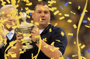 NEW ORLEANS, LA - JANUARY 03:  Head coach Brady Hoke of the Michigan Wolverines celebrates with the trophy after Michigan won 23-20 in overtime against the Virginia Tech Hokies during the Allstate Sugar Bowl at Mercedes-Benz Superdome on January 3, 2012 in New Orleans, Louisiana.  (Photo by Matthew Stockman/Getty Images)