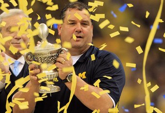 NEW ORLEANS, LA - JANUARY 03:  Head coach Brady Hoke of the Michigan Wolverines celebrates with the trophy after Michigan won 23-20 in overtime against the Virginia Tech Hokies during the Allstate Sugar Bowl at Mercedes-Benz Superdome on January 3, 2012 in New Orleans, Louisiana.  (Photo by Matthew Stockman/Getty Images)