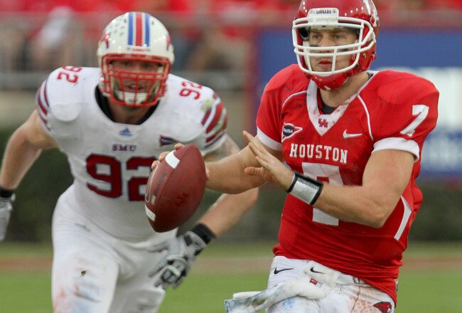 HOUSTON, TX - NOVEMBER 19: Quarterback Case Keenum #7 of the Houston Cougars rushes with the ball while defensive end Margus Hunt #92 of the Southern Methodist University Mustangs gives chase on November 19, 2011 at Robertson Stadium in Houston, Texas. (Photo by Thomas B. Shea/Getty Images)