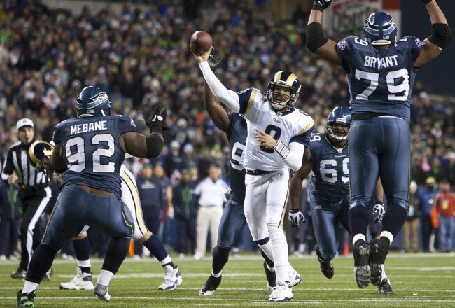 SEATTLE, WA - DECEMBER 12:  Sam Bradford #8 of the St. Louis Rams is surrounded by the Seattle Seahawks defense at CenturyLink Field December 12, 2011 in Seattle, Washington. Seattle won 33-13. (Photo by Jay Drowns/Getty Images)