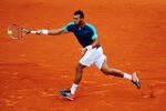 PARIS, FRANCE - JUNE 01:  Jo-Wilfried Tsonga of France returns during his men's singles third round match against Fabio Fognini of Italy during day six of the French Open at Roland Garros on June 1, 2012 in Paris, France.  (Photo by Mike Hewitt/Getty Images)