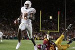 PASADENA, CA - JANUARY 04:  Vince Young #10 of the Texas Longhorns runs past Frostee Rucker #90 of the USC Trojans to score a touchdown and put the Longhorns up by one in the final moments of the BCS National Championship Rose Bowl Game at the Rose Bowl on January 4, 2006 in Pasadena, California.  Texas defeated USC 41-38.  (Photo by Harry How/Getty Images)