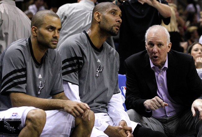 SAN ANTONIO, TX - MAY 29:  (R-L) Head coach Gregg Popovich of the San Antonio Spurs talks to Tim Duncan #21 and Tony Parker #9 on the bench in the third quarter while taking on the Oklahoma City Thunder in Game Two of the Western Conference Finals of the 2012 NBA Playoffs at AT&T Center on May 29, 2012 in San Antonio, Texas. NOTE TO USER: User expressly acknowledges and agrees that, by downloading and or using this photograph, user is consenting to the terms and conditions of the Getty Images License Agreement.  (Photo by Tom Pennington/Getty Images)