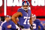 EAST RUTHERFORD, NJ - JANUARY 01:   Osi Umenyiora #72 of the New York Giants looks on against the Dallas Cowboys at MetLife Stadium on January 1, 2012 in East Rutherford, New Jersey.  (Photo by Rich Schultz/Getty Images)
