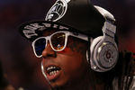 ORLANDO, FL - FEBRUARY 26:  Hip-hop artists Lil' Wayne, wearing diamond studded beats headphones by Dr. Dre sits courtside during the 2012 NBA All-Star Game at the Amway Center on February 26, 2012 in Orlando, Florida.  NOTE TO USER: User expressly acknowledges and agrees that, by downloading and or using this photograph, User is consenting to the terms and conditions of the Getty Images License Agreement.  (Photo by Ronald Martinez/Getty Images)