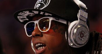 ORLANDO, FL - FEBRUARY 26:  Hip-hop artists Lil' Wayne, wearing diamond studded beats headphones by Dr. Dre sits courtside during the 2012 NBA All-Star Game at the Amway Center on February 26, 2012 in Orlando, Florida.  NOTE TO USER: User expressly acknowledges and agrees that, by downloading and or using this photograph, User is consenting to the terms and conditions of the Getty Images License Agreement.  (Photo by Ronald Martinez/Getty Images)