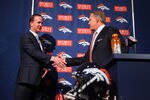 ENGLEWOOD, CO - MARCH 20:  Quarterback Peyton Manning (R) shakes hands with executive vice president of football operations John Elway during a news conference announcing Manning's contract with the Denver Broncos in the team meeting room at the Paul D. Bowlen Memorial Broncos Centre on March 20, 2012 in Englewood, Colorado. Manning, entering his 15th NFL season, was released by the Indianapolis Colts on March 7, 2012, where he had played his whole career. It has been reported that Manning will sign a five-year, $96 million offer.  (Photo by Doug Pensinger/Getty Images)