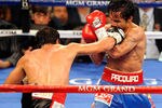 LAS VEGAS, NV - NOVEMBER 12:  Juan Manuel Marquez (L) throws a right at Manny Pacquiao during the ninth round of their WBO world welterweight title fight at the MGM Grand Garden Arena November 12, 2011 in Las Vegas, Nevada. Pacquiao retained his title with a majority decision victory.  (Photo by Ethan Miller/Getty Images)