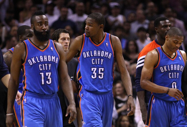 SAN ANTONIO, TX - MAY 27:  (L-R) James Harden #13, Kevin Durant #35 and Russell Westbrook #0 of the Oklahoma City Thunder walk off the court after losing 101-98 to the San Antonio Spurs in Game One of the Western Conference Finals of the 2012 NBA Playoffs at AT&T Center on May 27, 2012 in San Antonio, Texas. NOTE TO USER: User expressly acknowledges and agrees that, by downloading and or using this photograph, user is consenting to the terms and conditions of the Getty Images License Agreement.  (Photo by Ronald Martinez/Getty Images)
