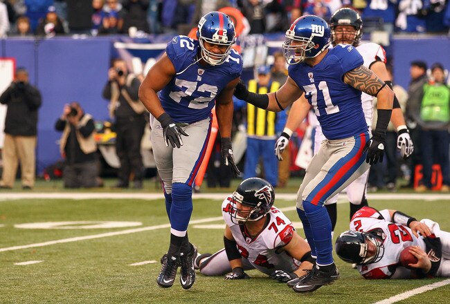 EAST RUTHERFORD, NJ - JANUARY 08:  (L-R) Osi Umenyiora #72 and Dave Tollefson #71 of the New York Giants celebrate after Umenyiora sacked Matt Ryan #2 of the Atlanta Falcons on the final play of the game during their NFC Wild Card Playoff game at MetLife Stadium on January 8, 2012 in East Rutherford, New Jersey. The Giants won 24-2.  (Photo by Al Bello/Getty Images)